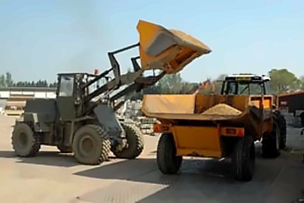 Loading shovel filling a dumper with aggregates in the William Hercock Melton Mowbray yard
